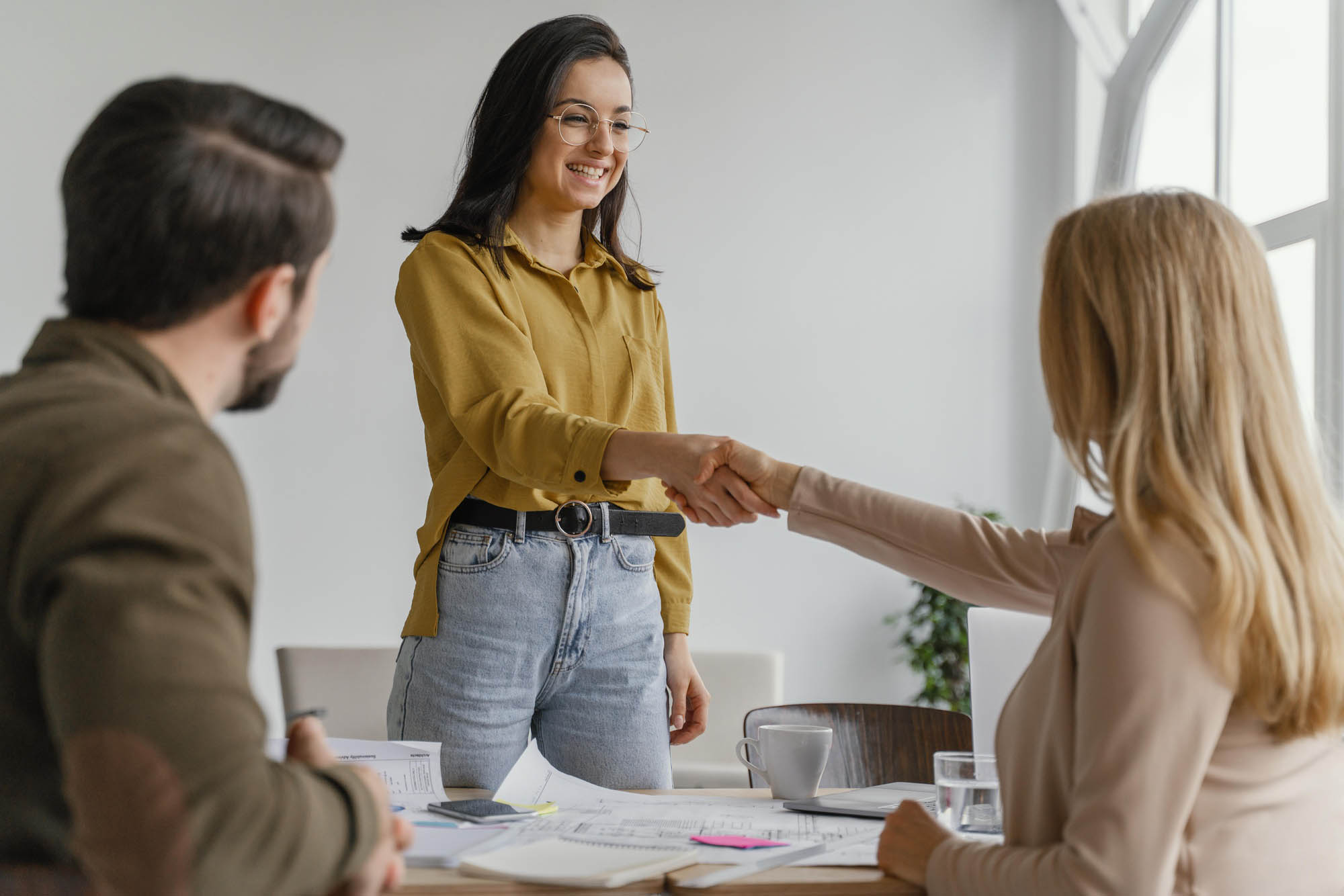 businesswomen shaking hands work | ANG