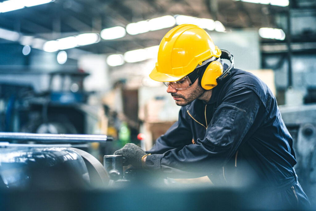 Industrial Engineers in Hard Hats. Manufacturing Factory. Industrial worker indoors in factory. man working in an industrial factory | ANG