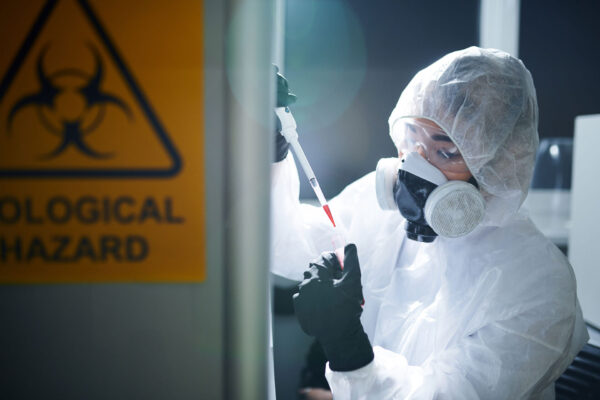 Gefahrenstoffe—-Concentrated-laboratory-scientist-in-protective-workwear,-rubber-gloves,-goggles-and-respirator-complying-with-safety-while-working-with-infected-substance Gefahrenstoffe----Concentrated-laboratory-scientist-in-protective-workwear,-rubber-gloves,-goggles-and-respirator-complying-with-safety-while-working-with-infected-substance