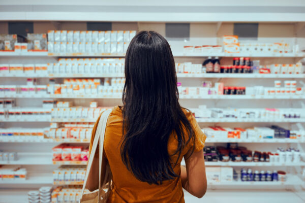 Pharma-Rear-view-of-young-woman-with-bag-standing-against-shelf-in-pharmacy-searching-for-medicine Pharma-Rear-view-of-young-woman-with-bag-standing-against-shelf-in-pharmacy-searching-for-medicine